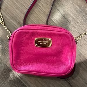 Dark pink Michael kors on the shoulder or to the side purse size small